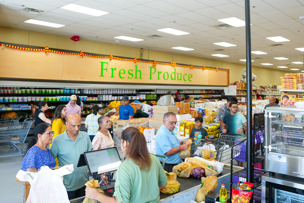 Friendly cashier helping customers at Reliance Mart checkout
