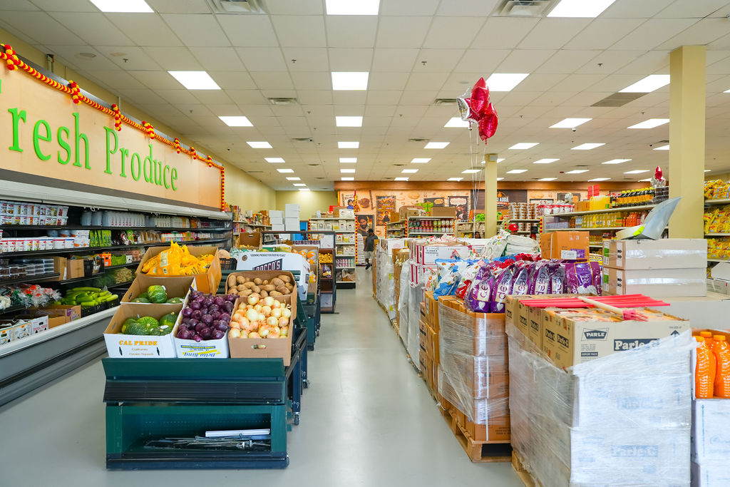 Fresh Produce aisle at Reliance Mart with vegetables and Parle biscuits