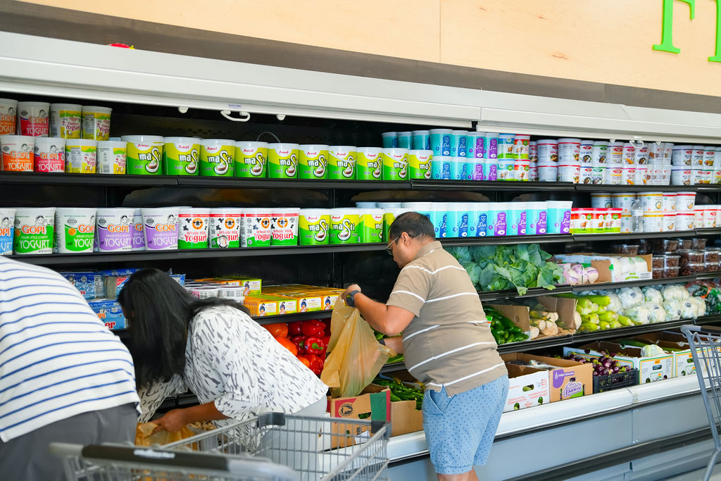 Shoppers picking fresh vegetables at Reliance Mart